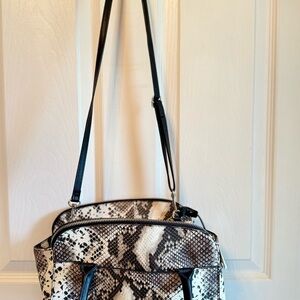 London Fog snake print handbag with black handles and trim.